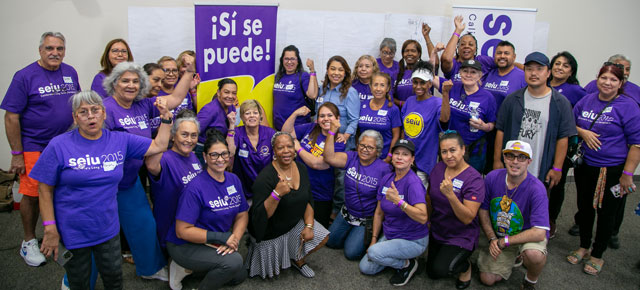 SEIU 2015 members wearing purple and holding fists at Democracy School in San Bernardino