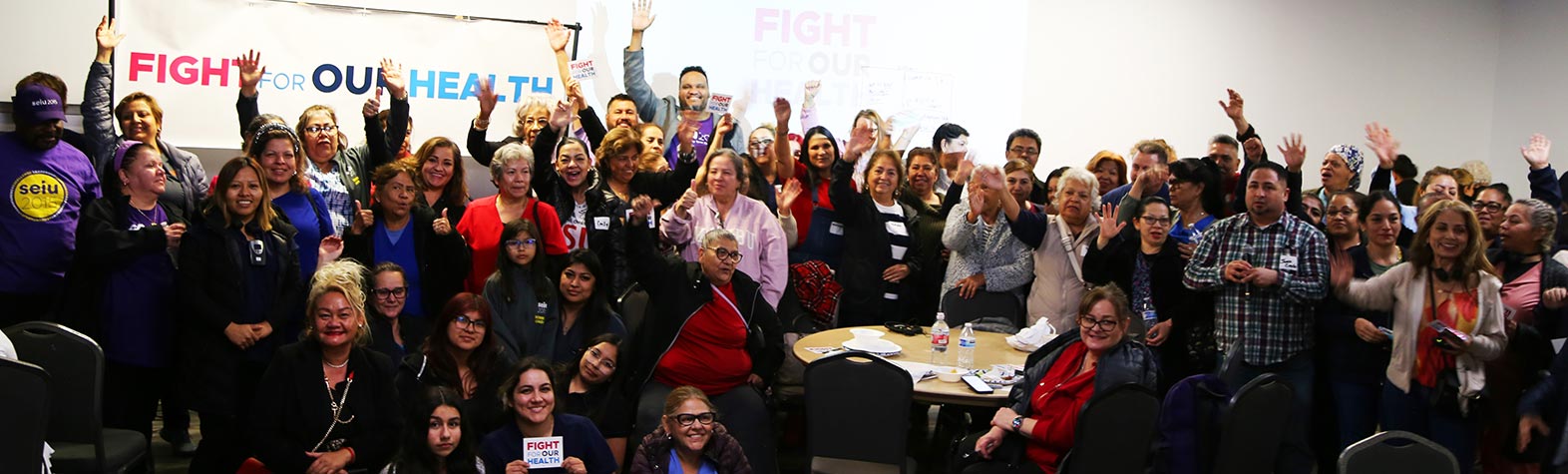 SEIU 2015 members in front of signs that read Fight for Our Health